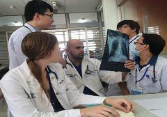 Physicians examining a lung x-ray