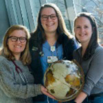 Global Health Students 3 Global Health Students holding a globe