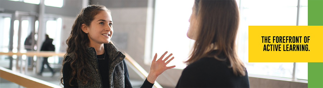 Two women talking in the hallway