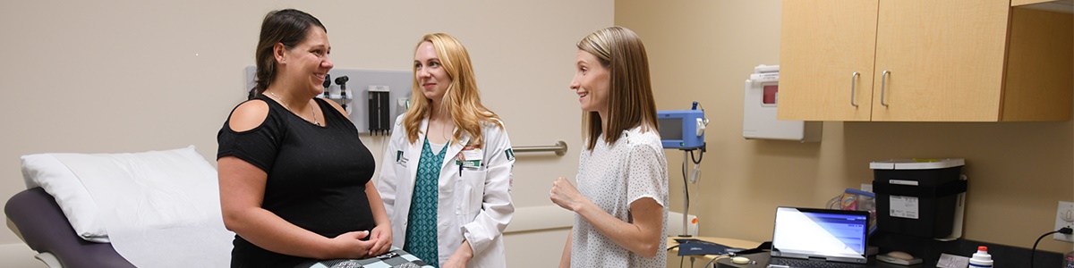 Physician and student with patient