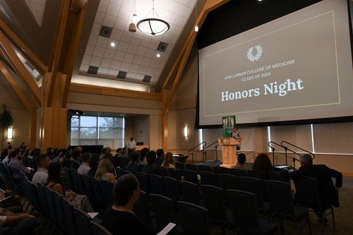Class of ’24 Honors Night large room full of people with screen behind lectern that says Honor Night