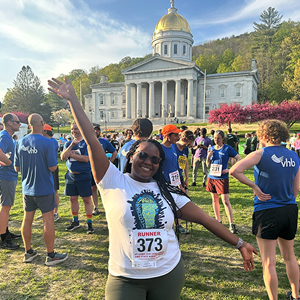 Excited LCOM Race participant with hands in the air