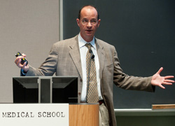 Dr. Alston speaking from a podium