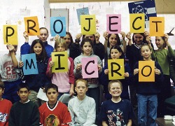 students holding project micro sign