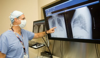 Physician examining X-ray