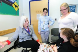 Female at exam with doctor, nurse
