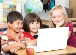 Children in school with laptop