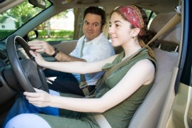 Teen girl driving with dad
