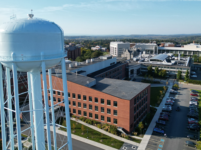 Water tower with Firestone Building