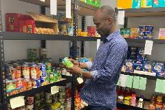 Mentee Pindar Mbaya looks at food in the food pantry the Bhurosy lab started