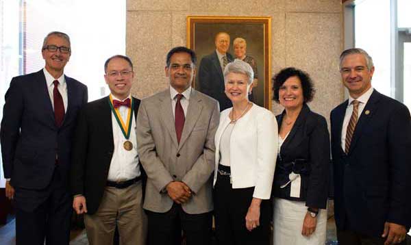 Fung posing with group at Green & Gold Professor Inauguration