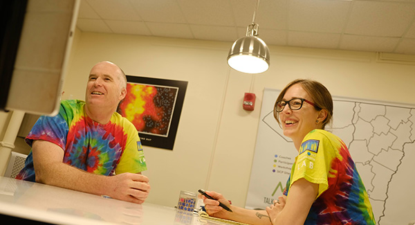 Dr. Gramling (left) and Francesca Arnoldy, palliative care doula, wearing their lab-themed t-shirts in the Vermont Conversation Lab in the Given Courtyard.