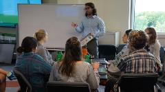 Photo of a Larner College of Medicine student facilitating a group tutoring session