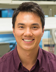 Dr. Huy Tu Dr. Huy Tu in lab smiling