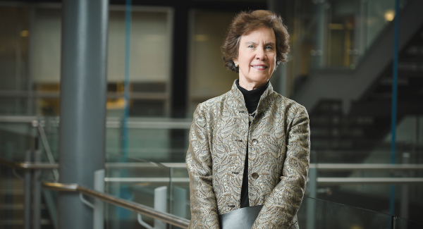 Jan Carney, M.D., M.P.H. standing in atrium