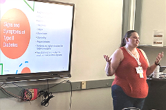 Larner medical student Taylor Krause ’27, AHEC scholar, mentors students at the GIV Summer Institute A female teacher stands in front of a classroom in front of a projection screen