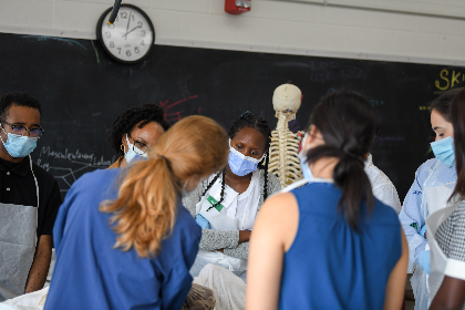 several look at larner participants observe a specimen in the anatomy lab