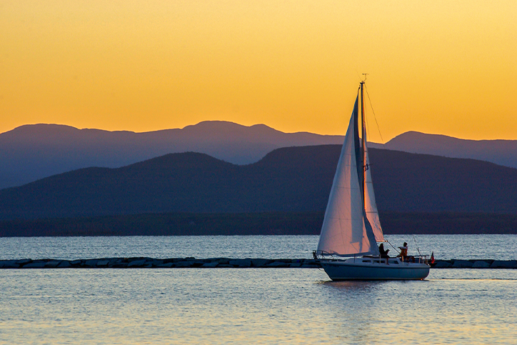 Sailboat sailing on lake Champlain during sunset