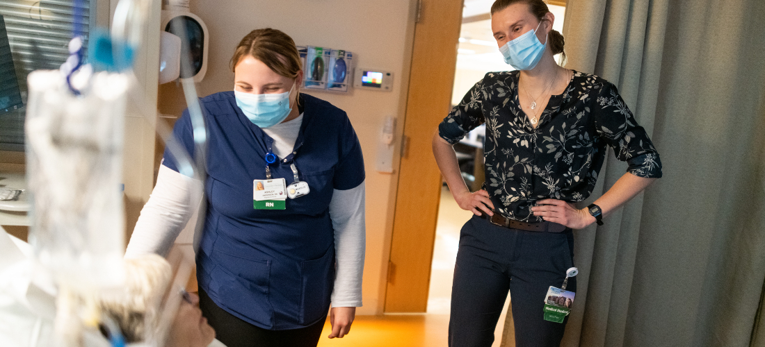 Medical student observes as a nurse cares for a patient in the hospital.