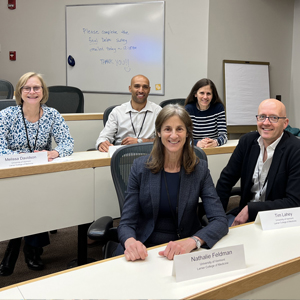 Group of LCOM faculty sitting together at conference