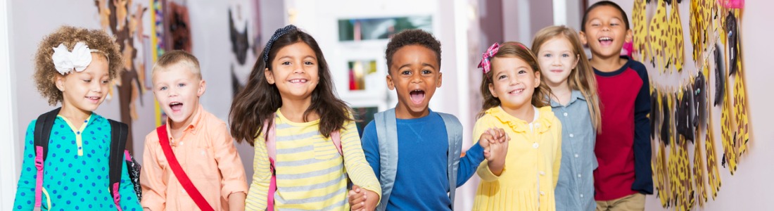 multiracial-group-of-preschoolers-running-down-hallway