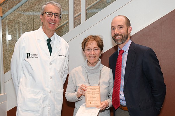 Dean Rick Page and Associate Professor of Surgery and Director of Active Learning Jesse Moore, M.D., present Professor of Medicine and Convergence Course Director Patricia King, M.D., Ph.D., with the inaugural Curriculum Innovation Award at the Class of ’22 Foundations Awards Celebration