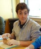 Photo of Colby McGinn practicing suturing during a clinic