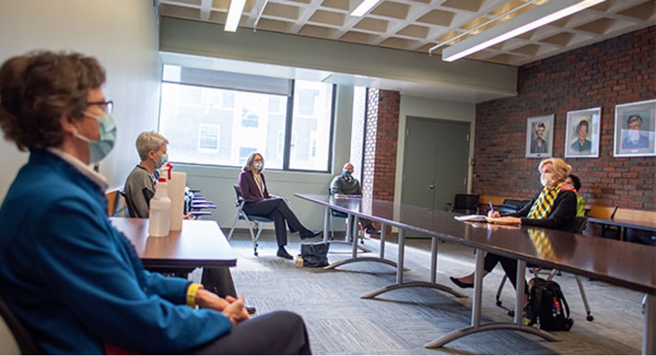 Drs. Carney (bottom left), Leonard (middle left), and Kirkpatrick (top left) meet with Dr. Birx (at right, at table).