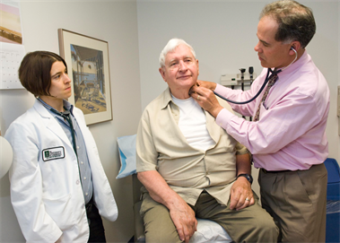 Photo of a physician precepting a student with patient