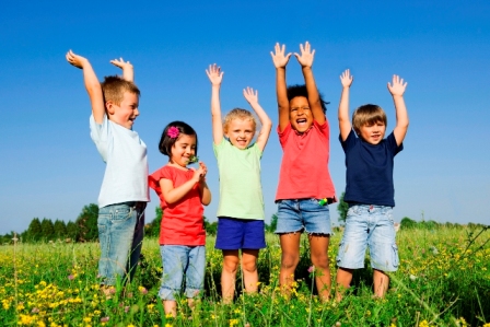 Children playing in summer Children cheering in the grass