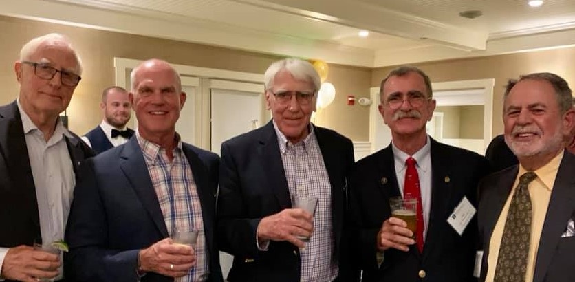 group of men holding drinks
