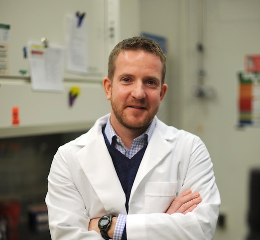 Sean Diehl, PhD Sean Diehl, PhD in lab coat smiling