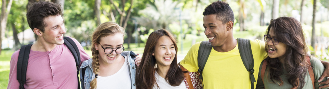 smiling teens walking in group