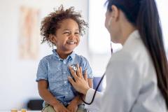 Photo of a Dr. treating a pediatric patient