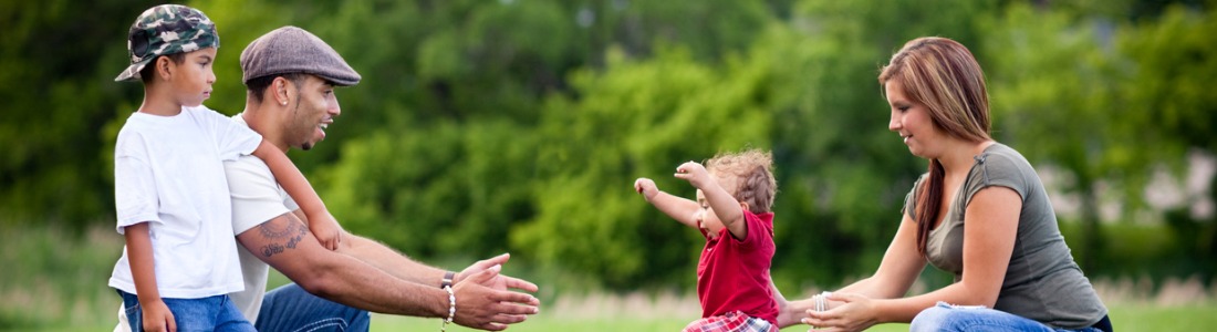 toddler-learning-to-walk-with-happy-family-outside