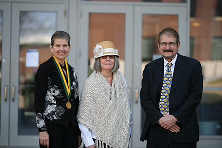 Three people posing in group