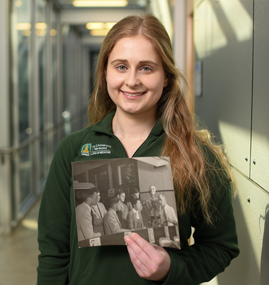 Mallory Stultz holding photo of her great-great grandfather Walter Stultz, Ph.D.