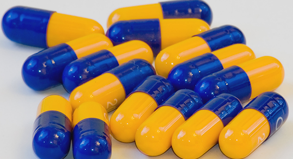 Yellow and blue pill capsules Yellow and blue pill capsules